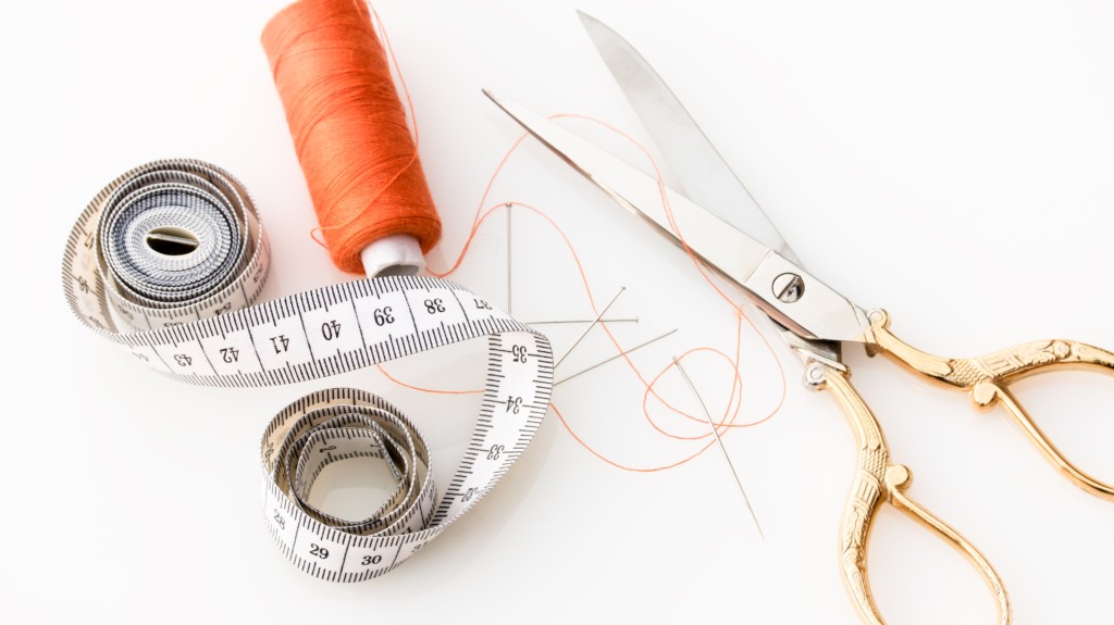 Scissors, thread, and a measuring tape for making a "patchwork" item—not unlike creating a patchwork procurement process