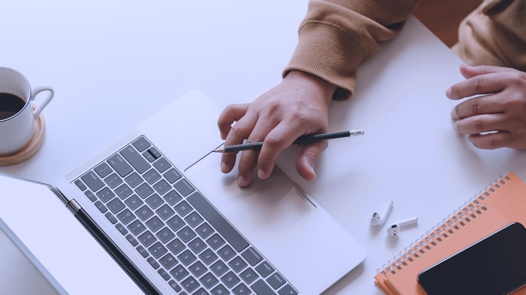 person on laptop using procurement technology for better outcomes organization-wide