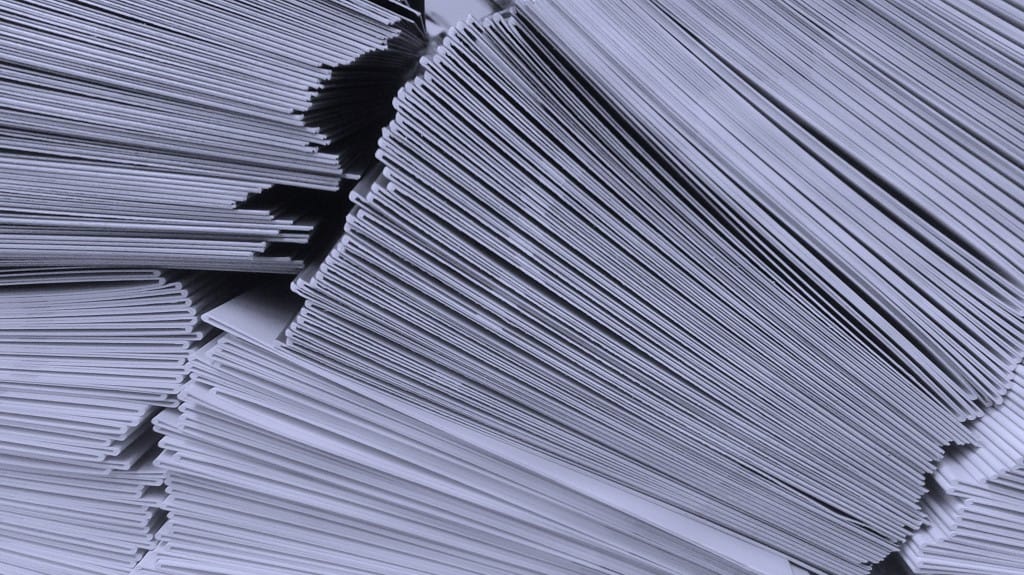 stacks of papers that eliminated in procurement process
