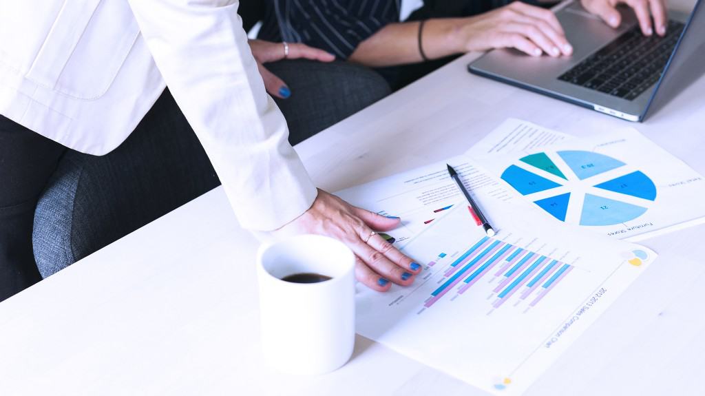 person looking at RFPs and statistics