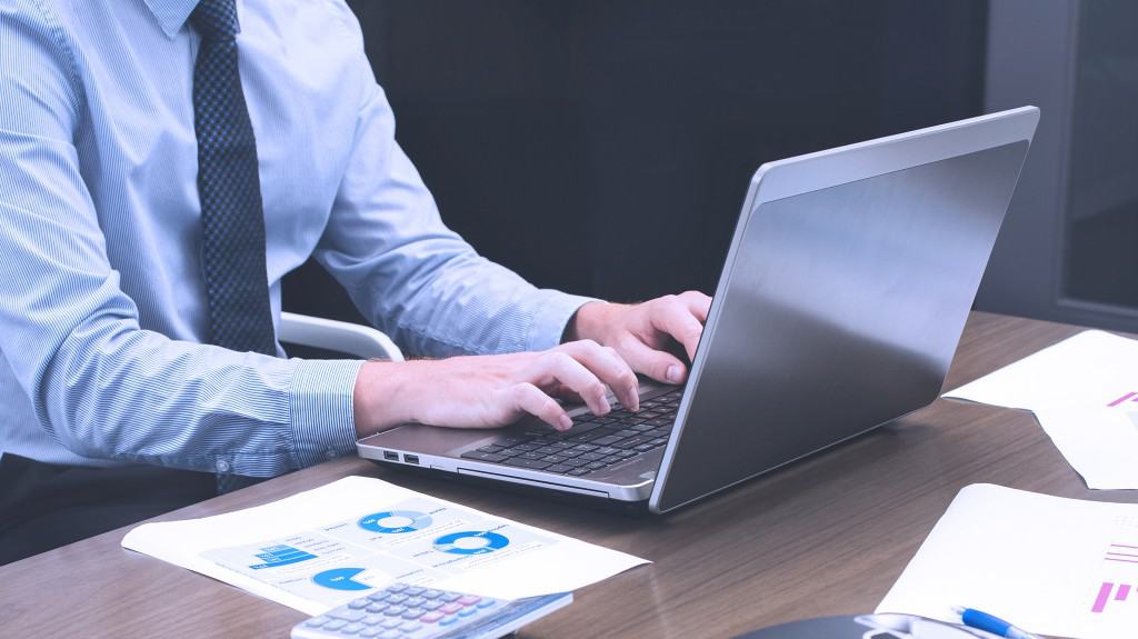 person typing large RFP data into computer