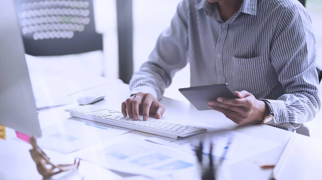 person using procurement software on devices