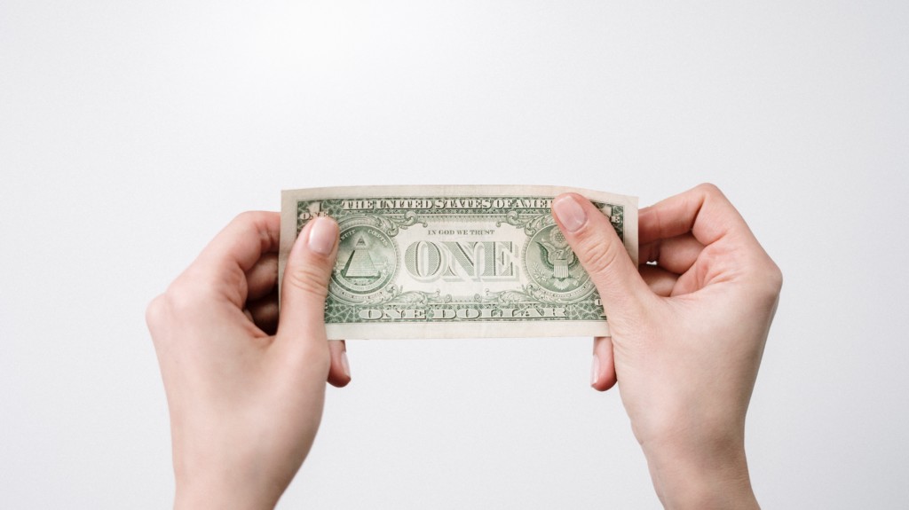 Hands holding U.S. dollars from ARPA funding